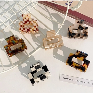 Close-up of assorted acetate rectangular hair claws in checkerboard and leopard prints