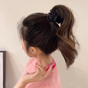 Matte black claw clip for high ponytail styling with minimalist curved design for women