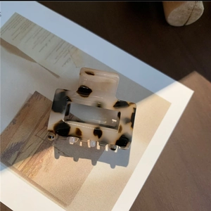 Close-up of tortoise shell pattern acetate hair claw clip with square hollow design