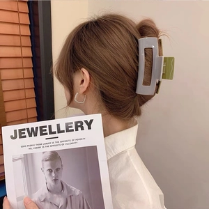 Elegant checkered acetate claw clip in light blue and green on a model for hair styling