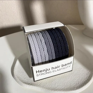Detail of high elasticity hair bands in neutral tones neatly packed in a minimal box