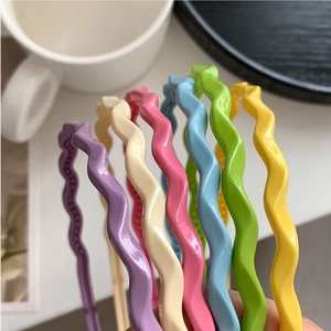 Detail showing smooth candy-colored wavy headbands in six vibrant pastel shades