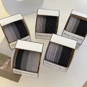 Elastic hair band set in assorted colors including black and grey in branded box