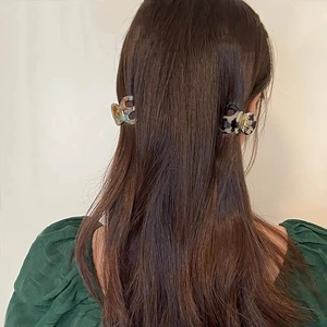 Elegant tortoiseshell and marble acetate hair claws for high ponytail styling on brunette hair