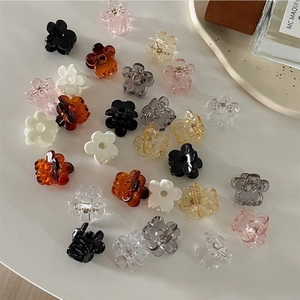 Macro shot of assorted colorful mini flower hair claw clips with resin finish