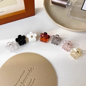 Mini flower hair claws in seven colors including amber and pink for women and girls