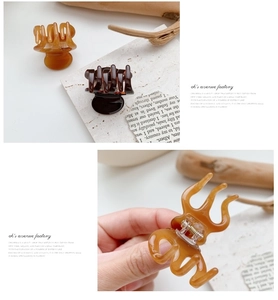 Detail of amber and dark brown resin hair claw clips with strong metal spring and teeth