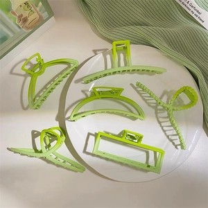 Set of 6 light green large matte hair claw clips for women on elegant white plate