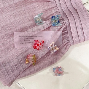 Close-up of small colorful gradient butterfly hair clips with marble texture acrylic