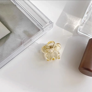 Detailed top view of a mini bear-shaped hair claw clip in transparent yellow resin