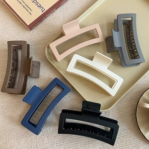 Large matte rectangular claw clips in six colors for thick hair styled on aesthetic books