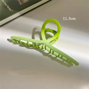 Macro view of 11.3cm matte grass green hair claw clip with cross-tooth design for thick hair