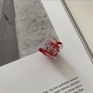 Detailed close-up of marble pattern butterfly hair claw clip on a magazine page