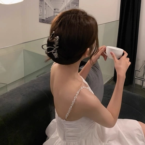 Elegant silver metal tulip hair claw clip with pearls worn on back of head with white dress