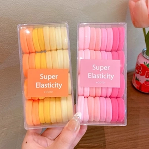 Gros plan sur des chouchous colorés haute élasticité en boîtes transparentes