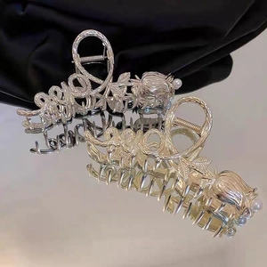 Silver metal hair claw featuring hollow LOVE letters, delicate flowers and pearls