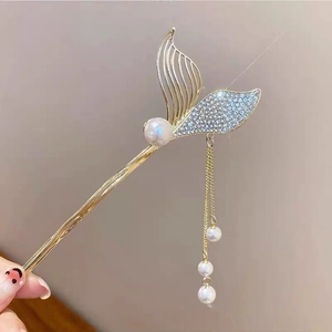 Golden mermaid tail hair pin with sparkling rhinestones, pearls and tassel detail