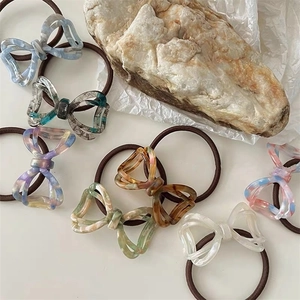 Close-up of acetic acid bow hair ties with various marble and floral textures