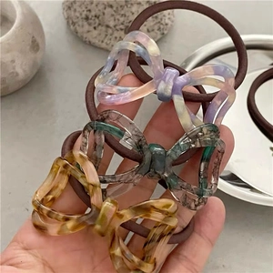 Three-piece acetate bow hair ties set with amber and marble patterns for high ponytails