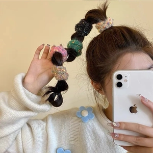 Set of colorful tweed-style knit hair scrunchies with soft texture for braided hairstyles
