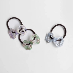 Three-piece set of acetate bow hair ties with marble texture in purple, green, and blue