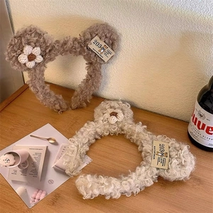 Cute lamb wool bear ear headband in beige and brown colors with hand-knitted floral accents