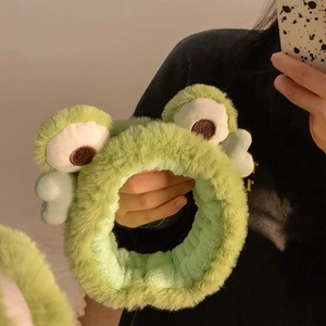 Cute green plush frog headband for women featuring soft microfiber and blue heart accents