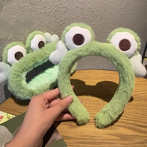 Cute green plush frog headband for women with big white eyes and soft furry texture