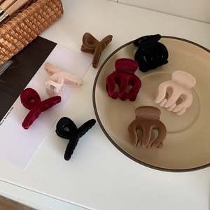 Detailed view of matte flocked hair claws in various autumn colors and different styles