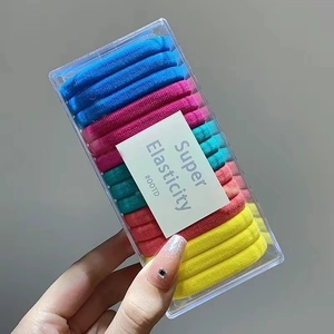 Detail of colorful high elasticity hair bands in a transparent rectangular storage box