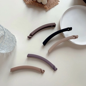Detailed set of five matte banana clips in morandi tones with minimalist twist design