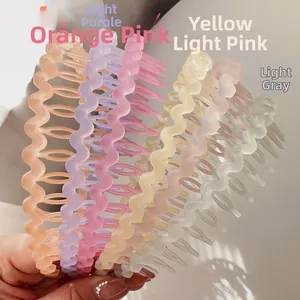 Detailed view of six colorful wavy headbands with teeth in various pastel matte colors