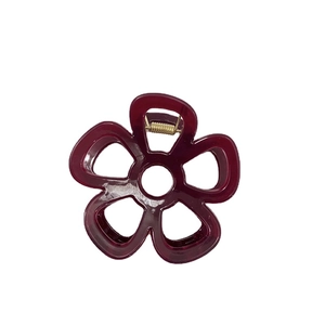 Elegante pinza per capelli a fiore rosso scuro con molla dorata su sfondo bianco