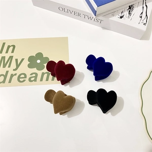 Detail of four flocked heart hair clips in burgundy, navy, coffee, and black tones