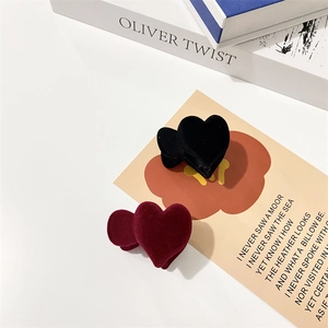 Detail of flocking velvet heart hair clips in black and burgundy on vintage art card