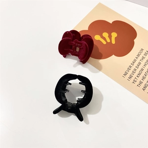 Close-up of wine red and black velvet heart hair claws for high ponytail styling