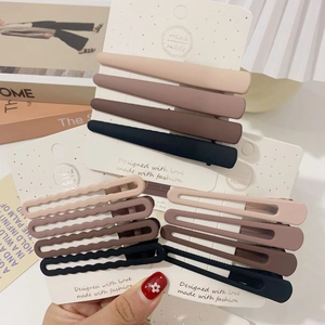 Close-up of Morandi colored matte hair clips set displayed on decorative white cards
