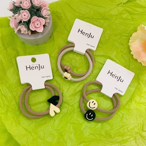 Set of 2 elastic hair bands with flower heart and smiley face charms on display card