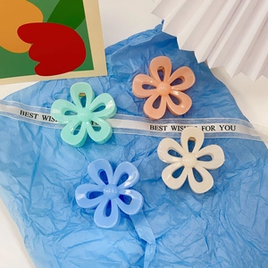 Set of four pastel floral hair claws in mint green, pink, blue, and cream acrylic