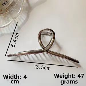 Detail of silver alloy shark hair clip with dimensions 13.5cm length and strong metal spring