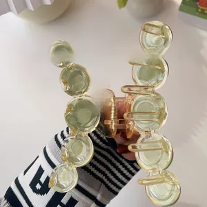 Detail of solid gradient acrylic hair claw clip showing the durable internal metal spring