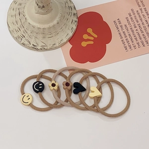 Set of 6 minimalist earth-toned hair ties with smiley flower and heart charms