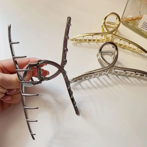 Large minimalist metal hair claw clips in gold, silver and grey for elegant hair styling