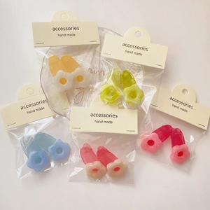 Set of colorful floral resin hair clips showing translucent texture and handmade packaging