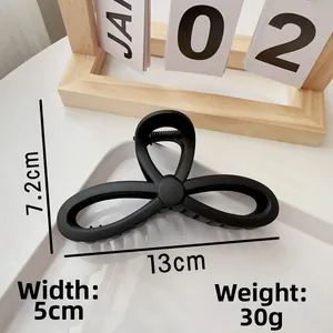 Detail view of large matte black claw clip with 13cm length dimensions and hollow design