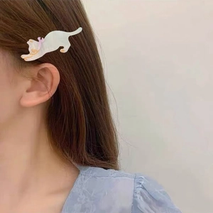 Cute acetate cat hair clip with purple bow detail worn as a side hair accessory