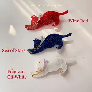 Three piece set of acrylic cat hair clips in wine red, starry blue, and creamy white