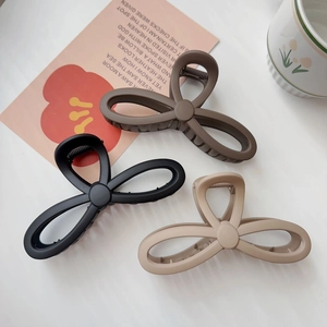 Three large matte claw clips in black, brown and beige for thick hair styling