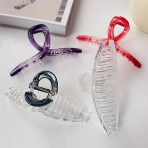 Set of large colorful matte hair clips for women in purple, red, black, and white