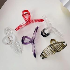 Detailed top view of five colorful large shark hair claws in red, purple, and green shades